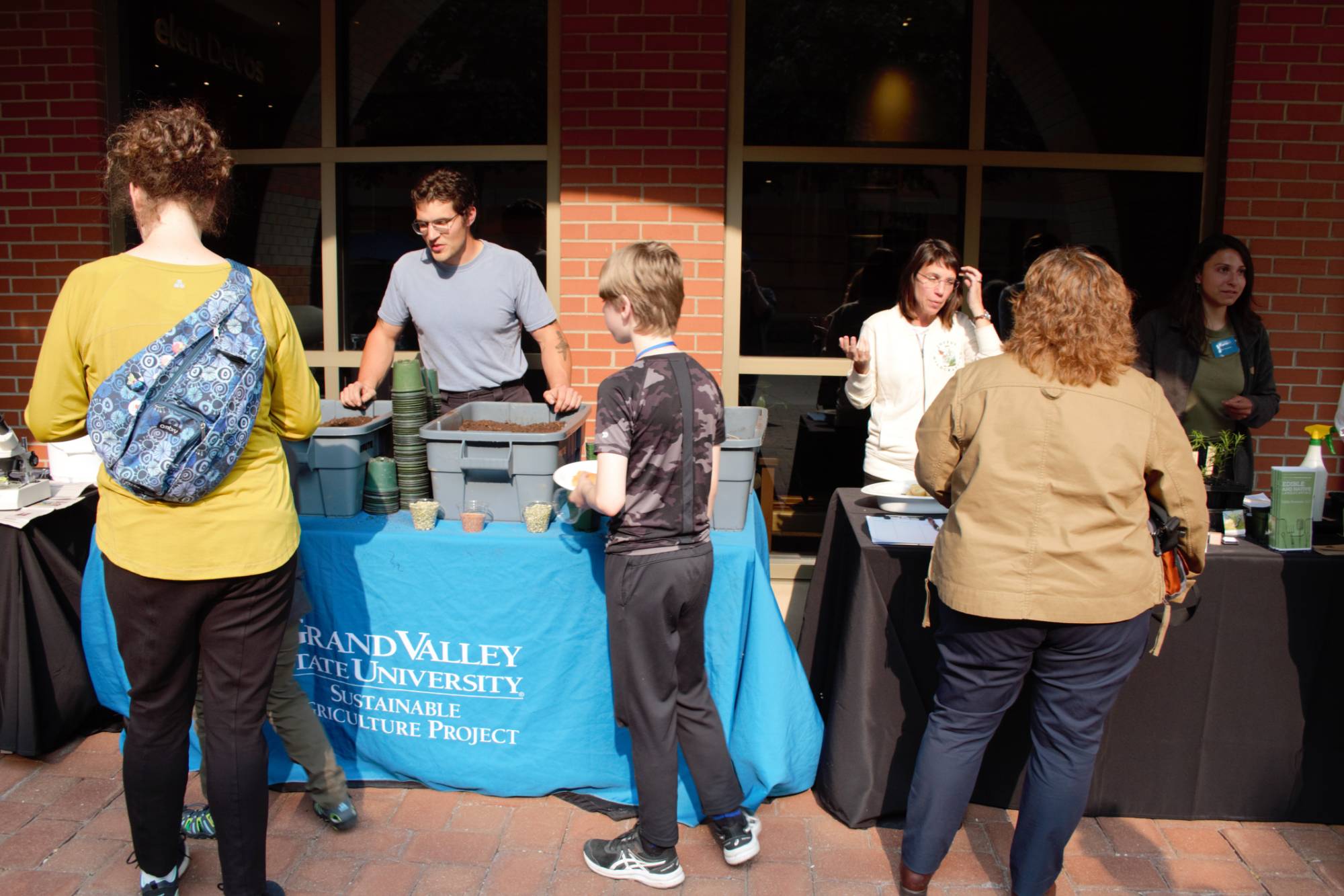 People visiting a partner table display at a Groundswell event